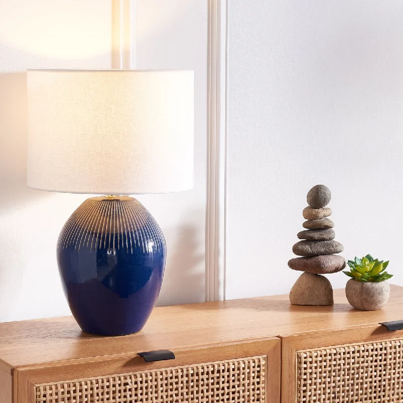 wooden table lamps with natural grain for a warm and organic feelwooden table lamps with natural grain for a warm and organic feelSAFAVIEH Lighting Mukta 20-inch Table Lamp - 13 In. W x 13 In. D x 20 In. H - 13Wx13Dx20H